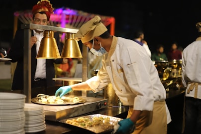 man in white chef uniform cooking