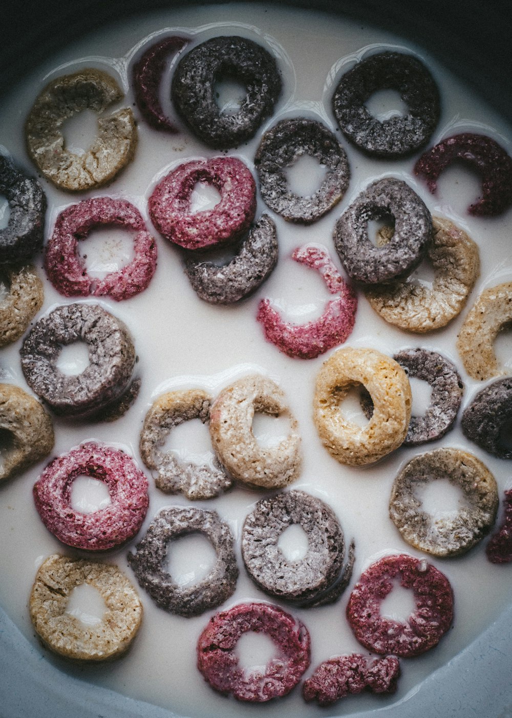 pink and brown donuts on white ceramic plate