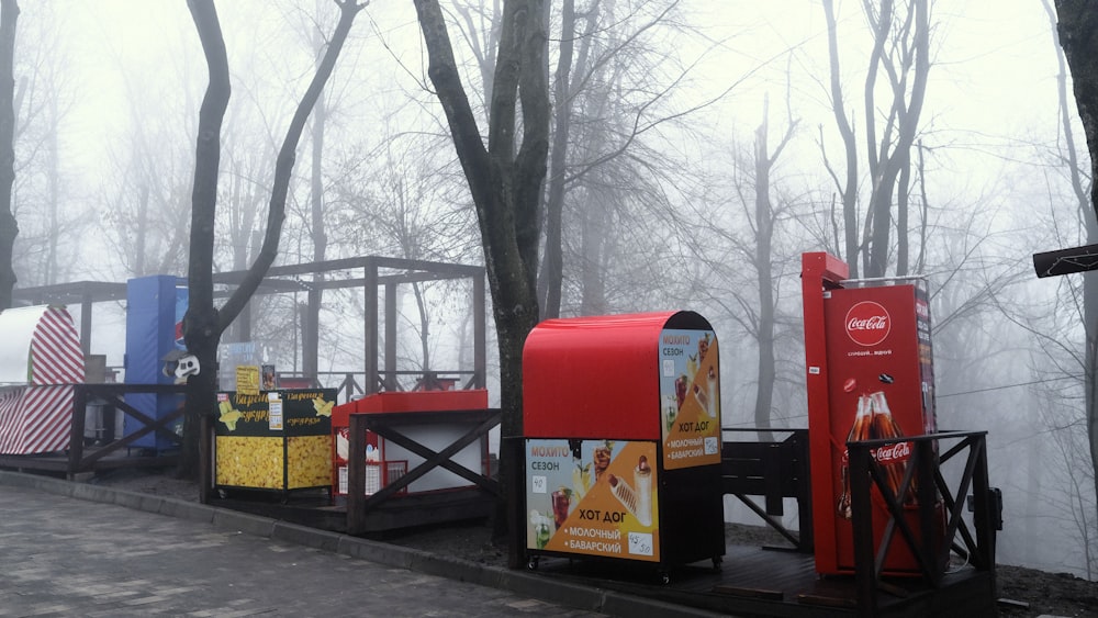 red and black mail box near brown wooden bench