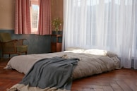 Comfortable bedroom with soft beige linens, promoting rest and dignity.