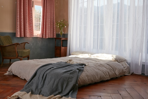 A cozy bedroom setting featuring soft, textured bed linens from Cezar Home Textiles