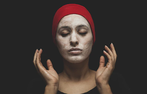 Person relaxing with face tape on, eyes closed, embodying self-care and clarity.