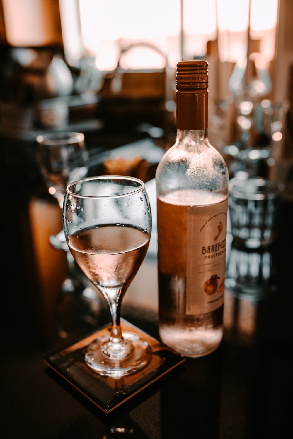 clear wine glass with brown liquid inside