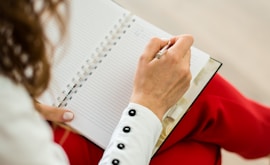 woman in red blazer holding white paper