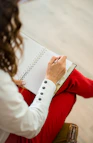 woman in red blazer holding white paper