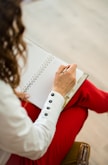 woman in red blazer holding white paper