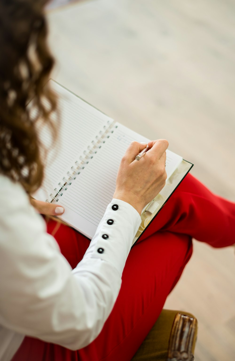 woman in red blazer holding white paper