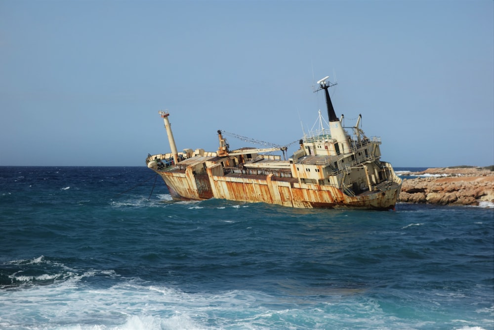 brown and white ship on sea during daytime