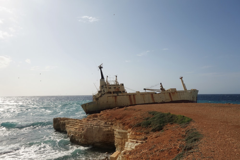 brown and white ship on sea during daytime