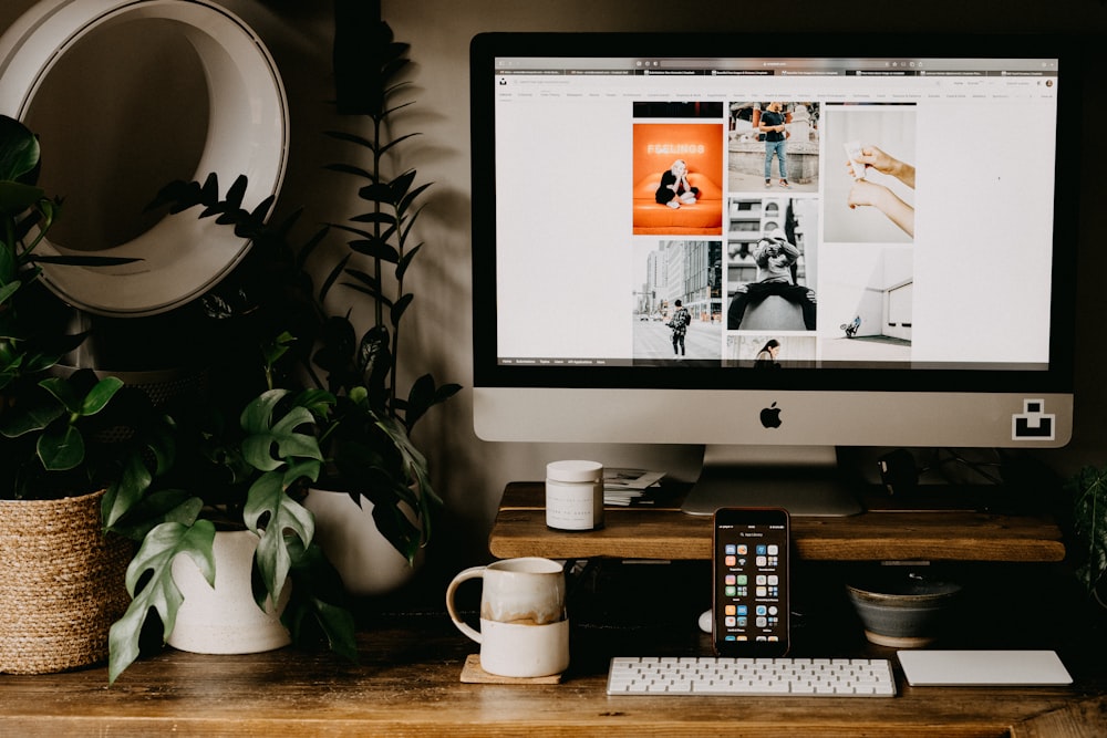 silver imac on brown wooden table