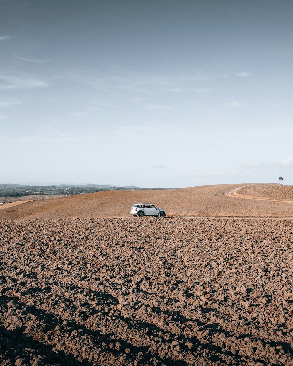 white car on brown sand during daytime