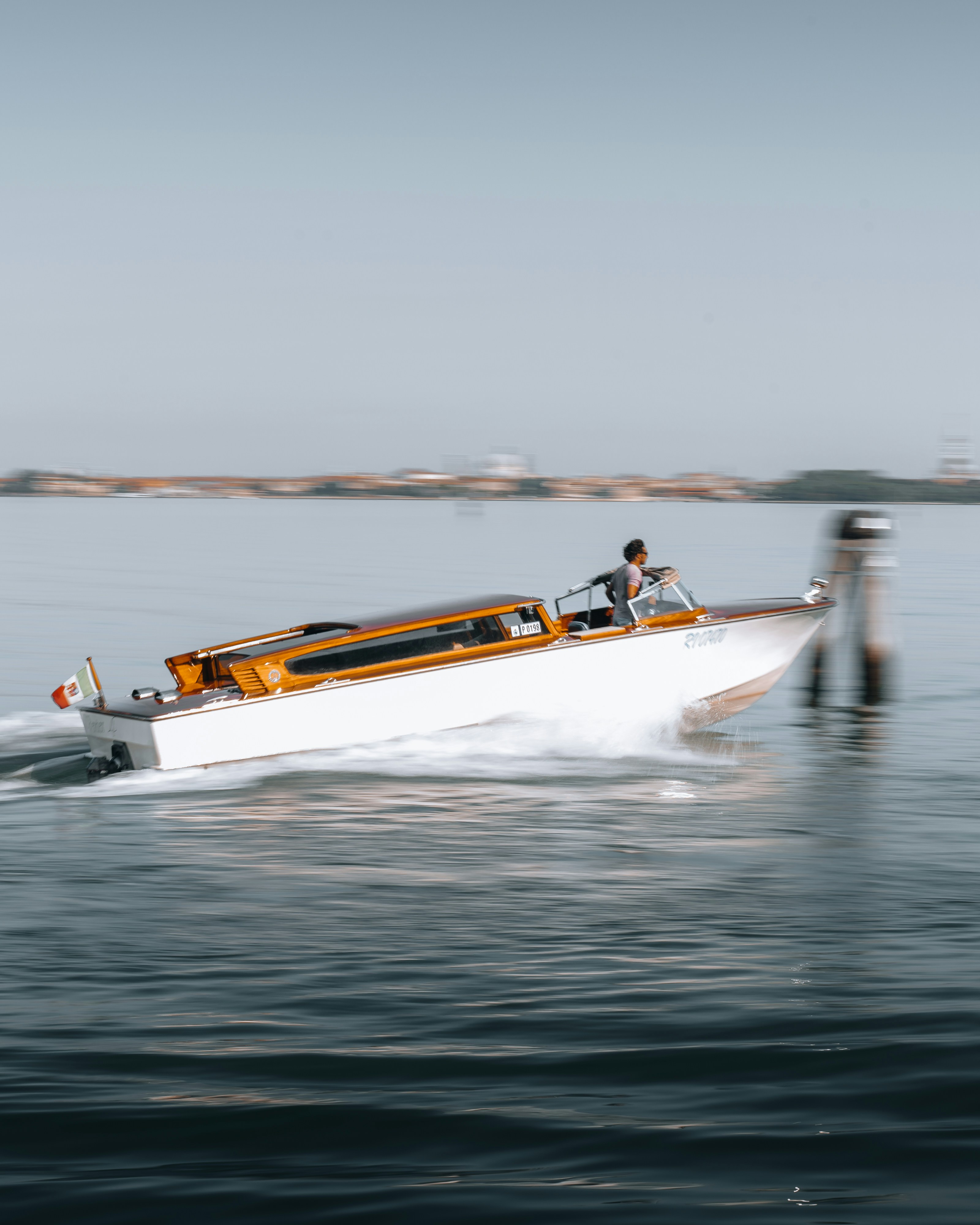 white and orange boat on sea during daytime