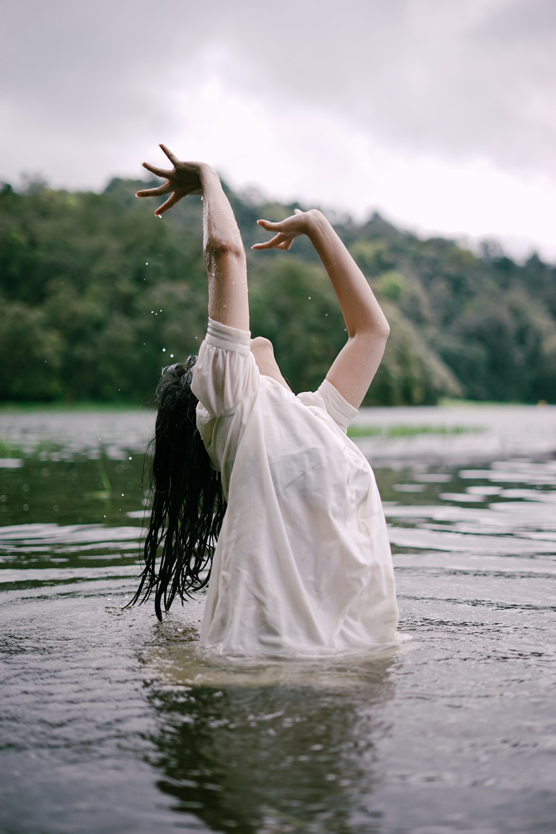 woman in white dress standing on water during daytime