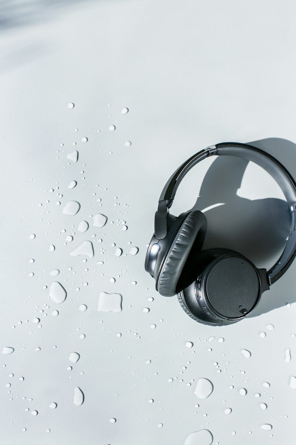 black and silver headphones on white surface