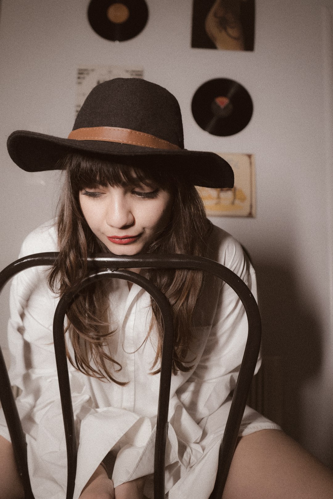 woman in white shirt wearing black fedora hat