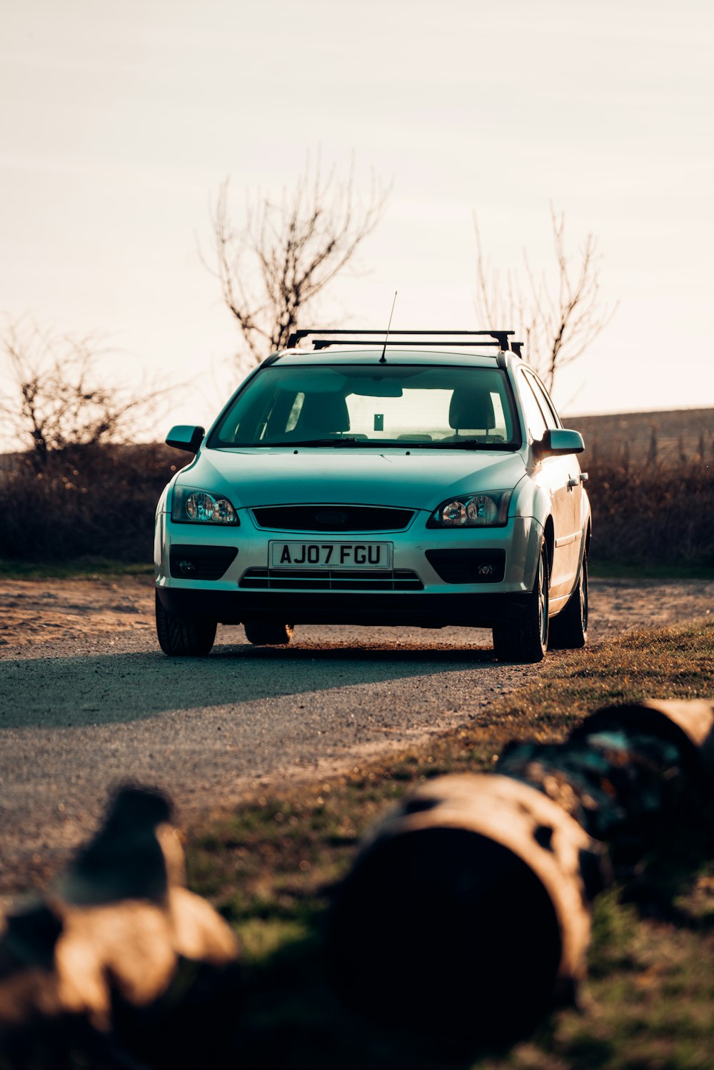 blue bmw m 3 on dirt road during daytime