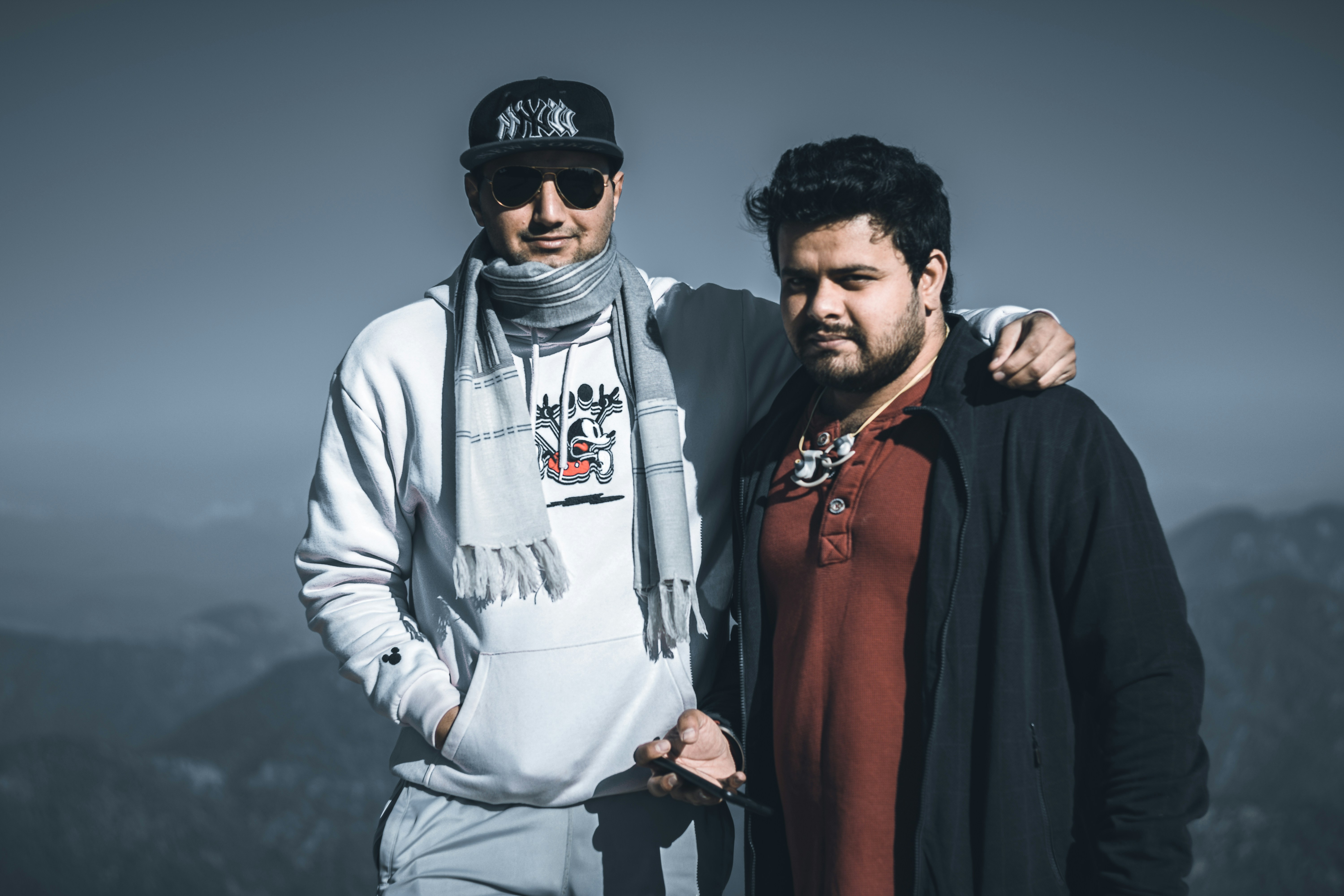 man in white jacket beside woman in red shirt