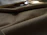 Close-up of a luxurious beige scrub fabric with soft natural lighting highlighting its texture.