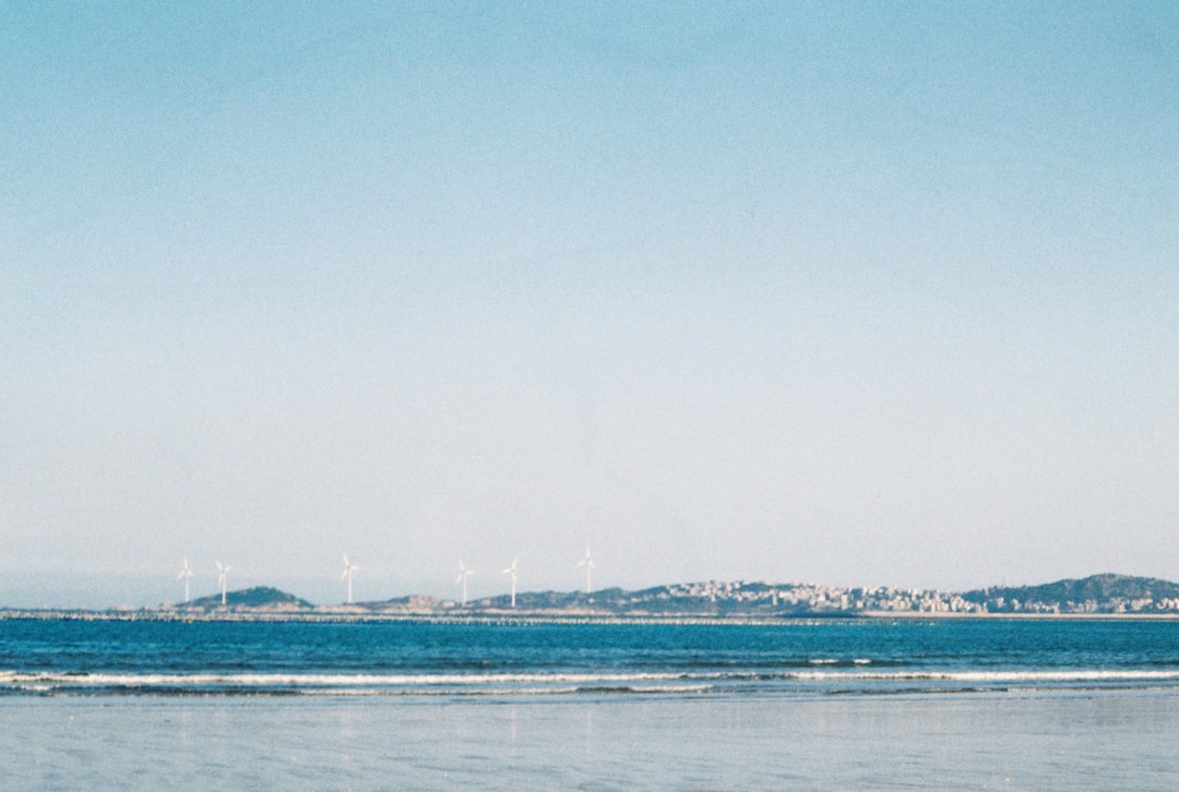 white boat on sea under blue sky during daytime