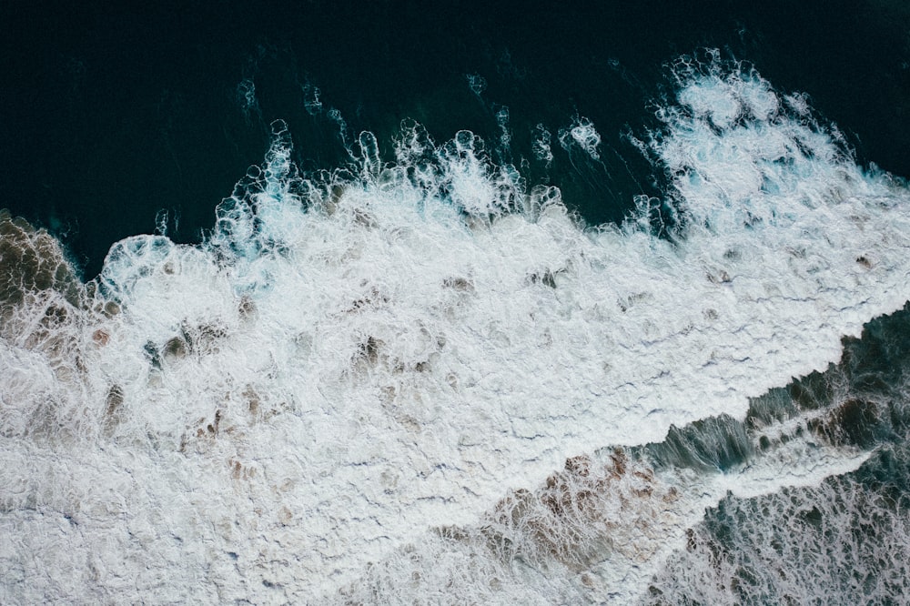 ocean waves crashing on shore during daytime