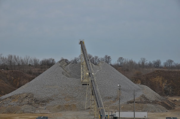 Close-up of crushed stone being processed on an industrial conveyor belt.
