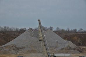 Close-up of crushed stone and gravel being processed on an industrial conveyor belt.