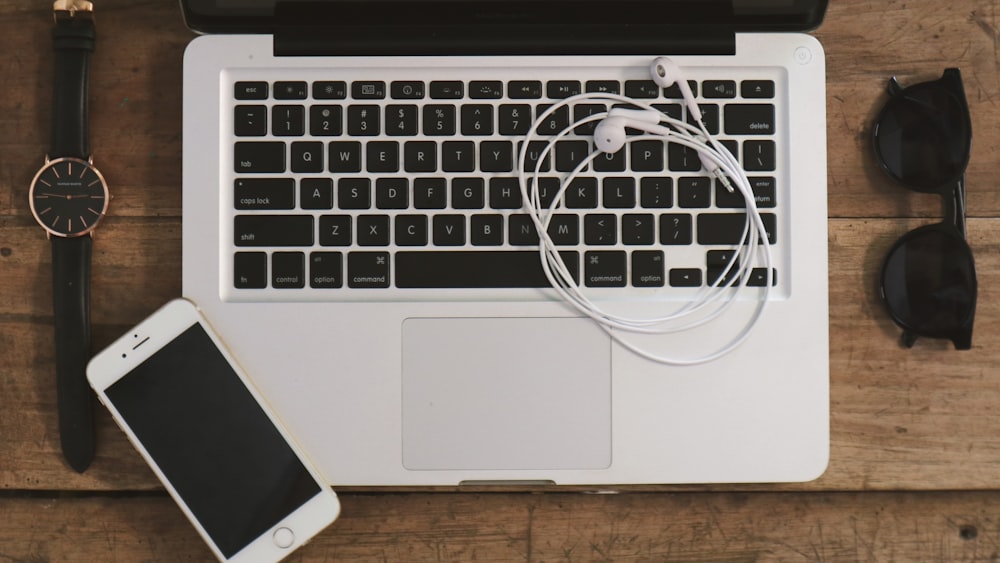 white earbuds on macbook pro