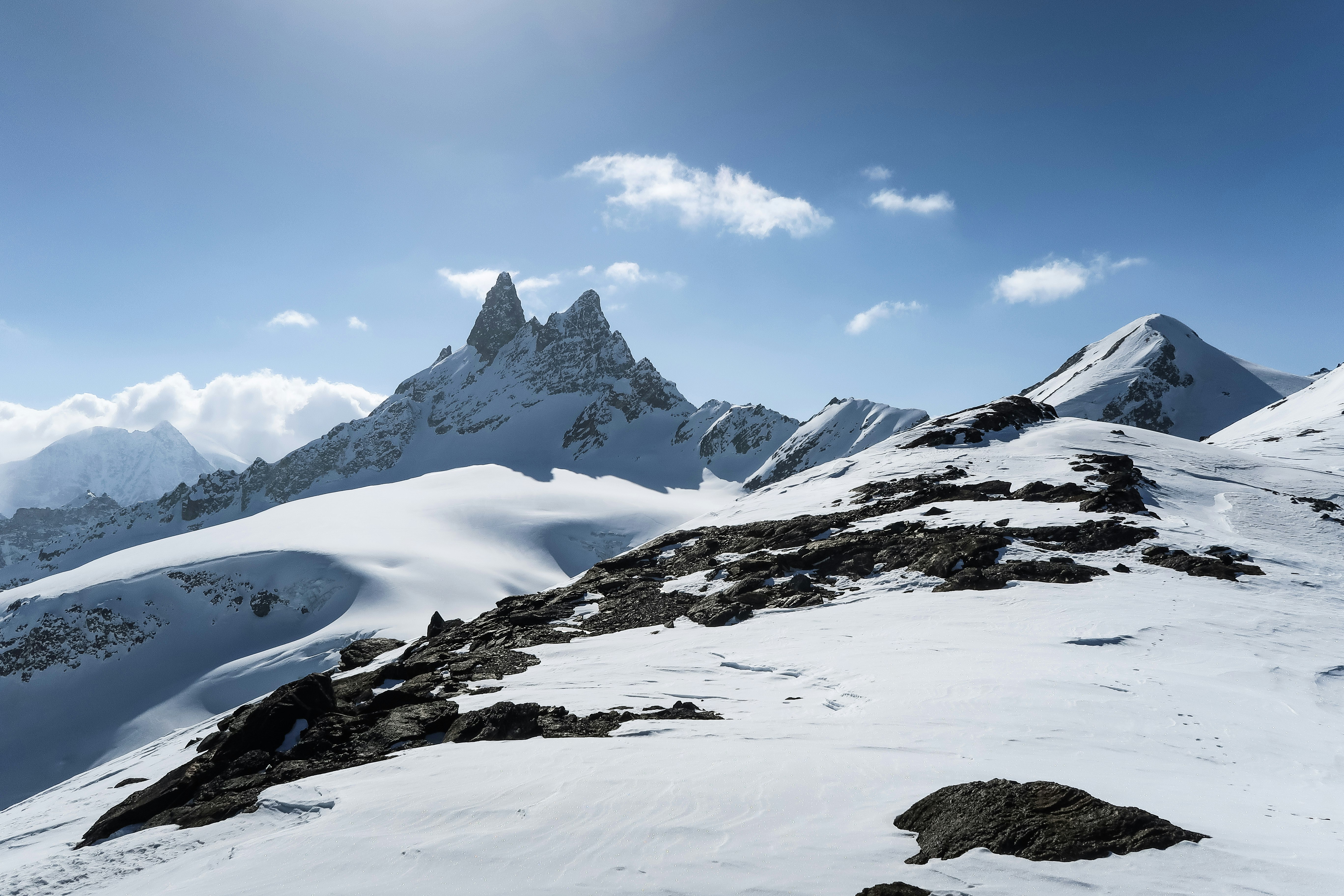 snow covered mountain under blue sky during daytime