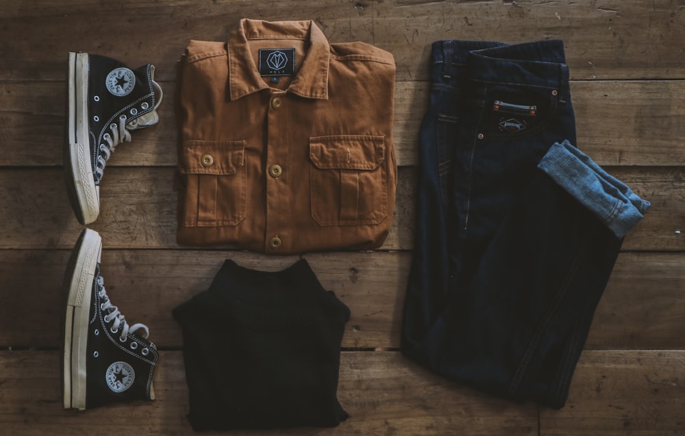 black denim button up shirt black pants black and silver dslr camera black denim button up