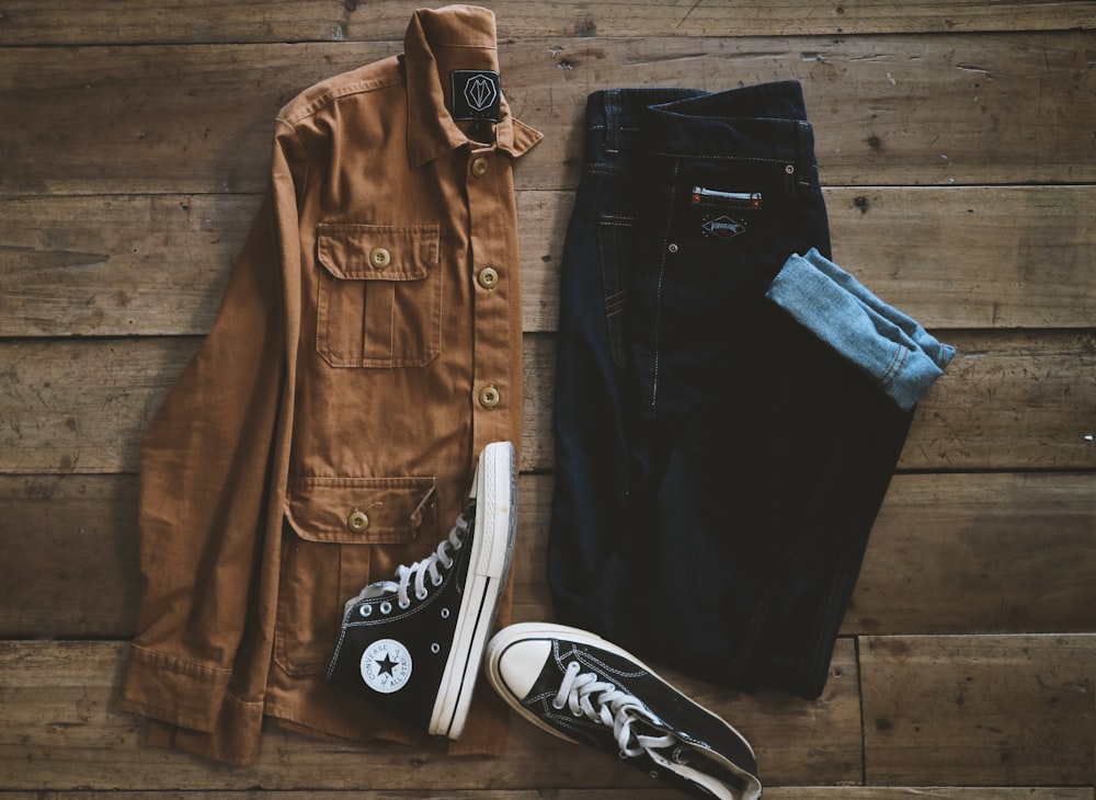 black and white converse all star high top sneakers beside black denim jeans