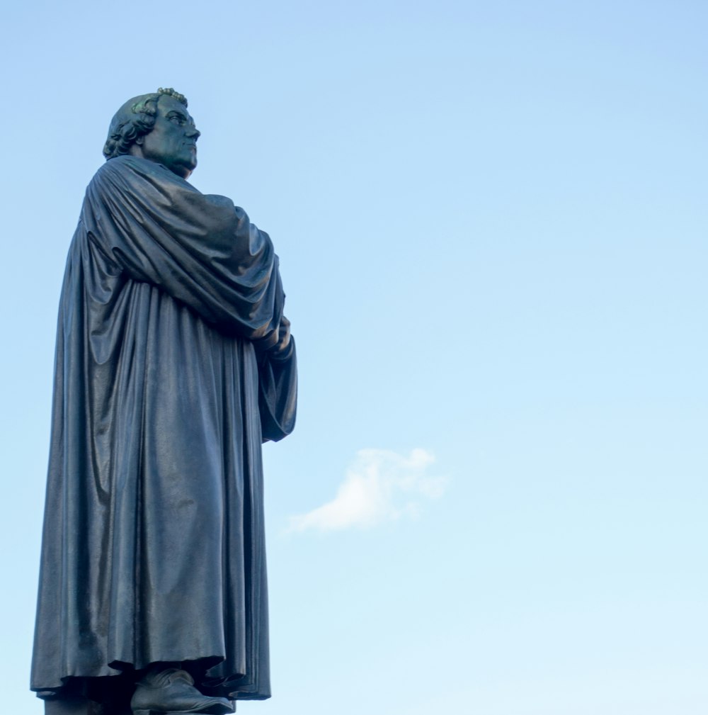 man in black coat statue