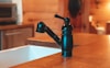 black and silver vacuum flask on brown wooden table