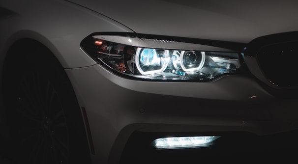 A close-up shot of sleek LED headlights shining brightly on a modern car.