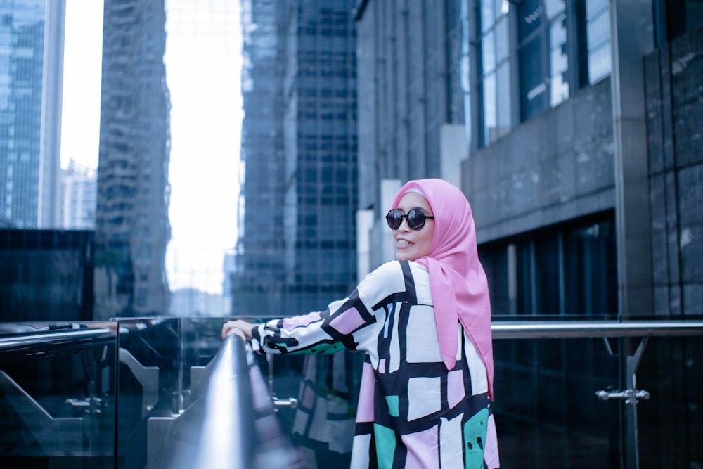 woman in pink hijab standing on the street