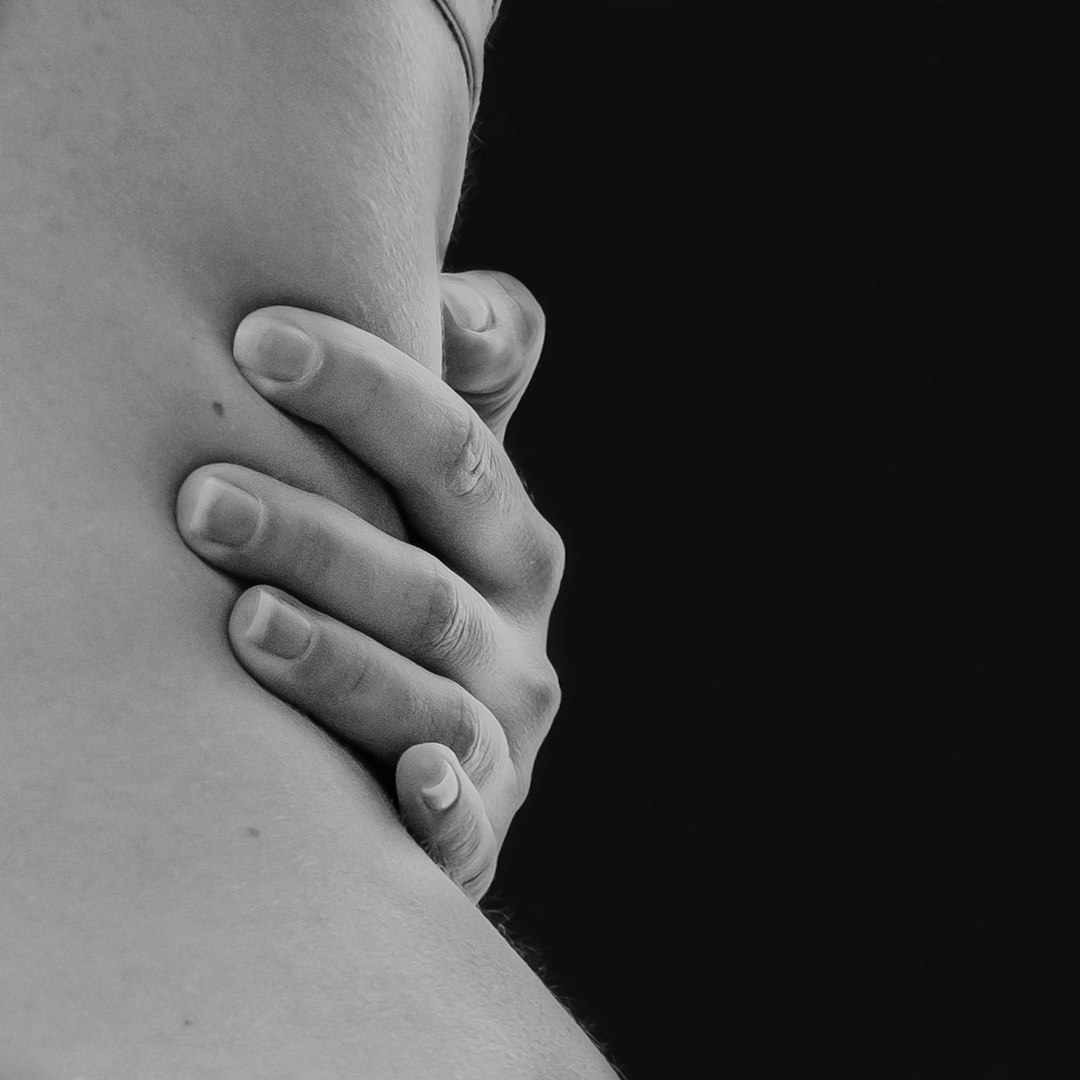 grayscale photo of couple holding hands