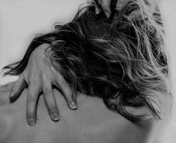 grayscale photo of woman covering her face