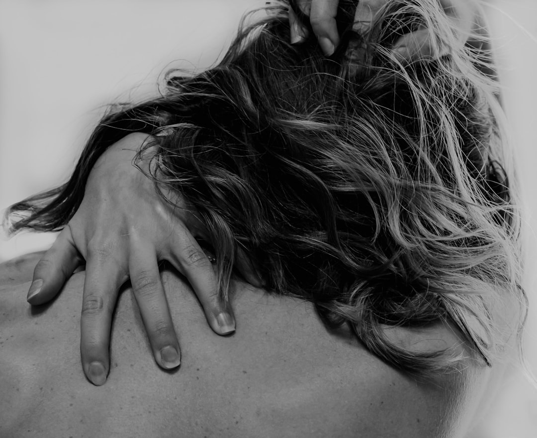 grayscale photo of woman covering her face