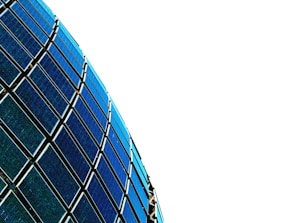 Curved rows of blue and black solar panels against a stark white background.