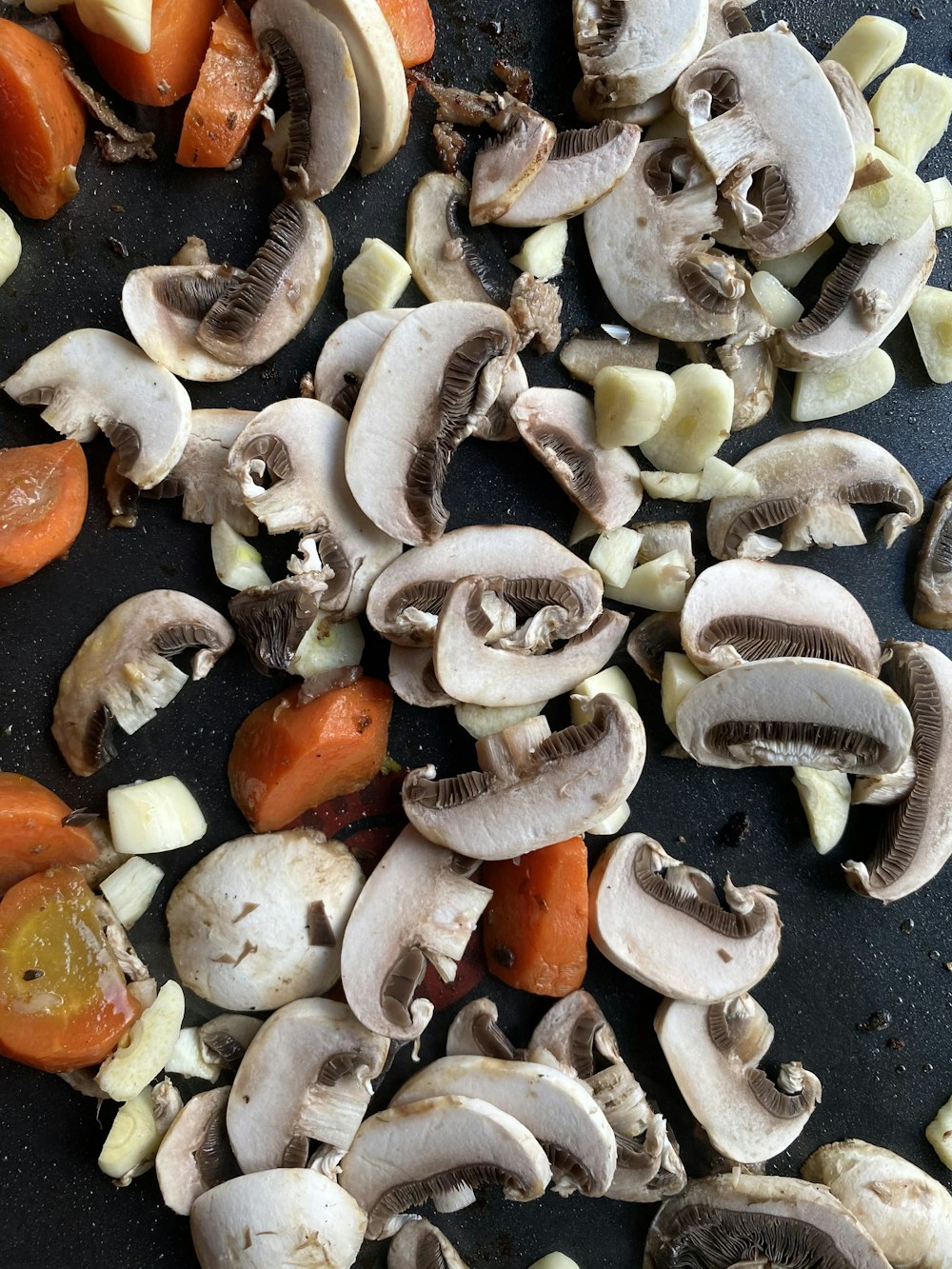 white and orange mushrooms on black textile