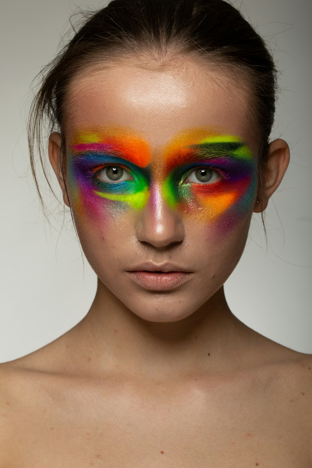 woman with green blue and purple face paint