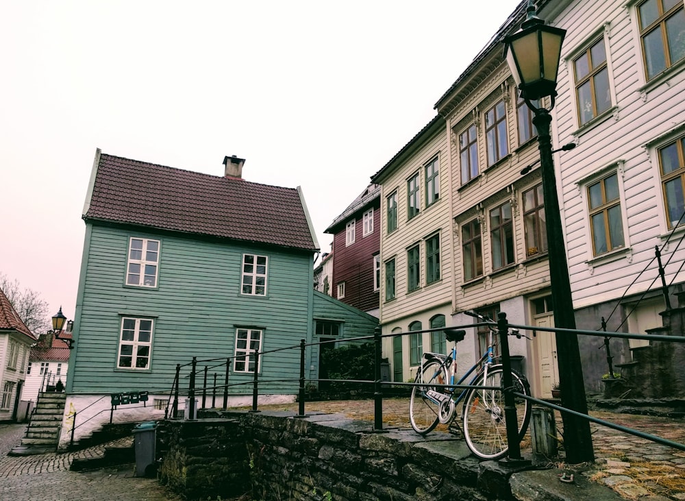 black bicycle parked beside brown and white concrete building during daytime