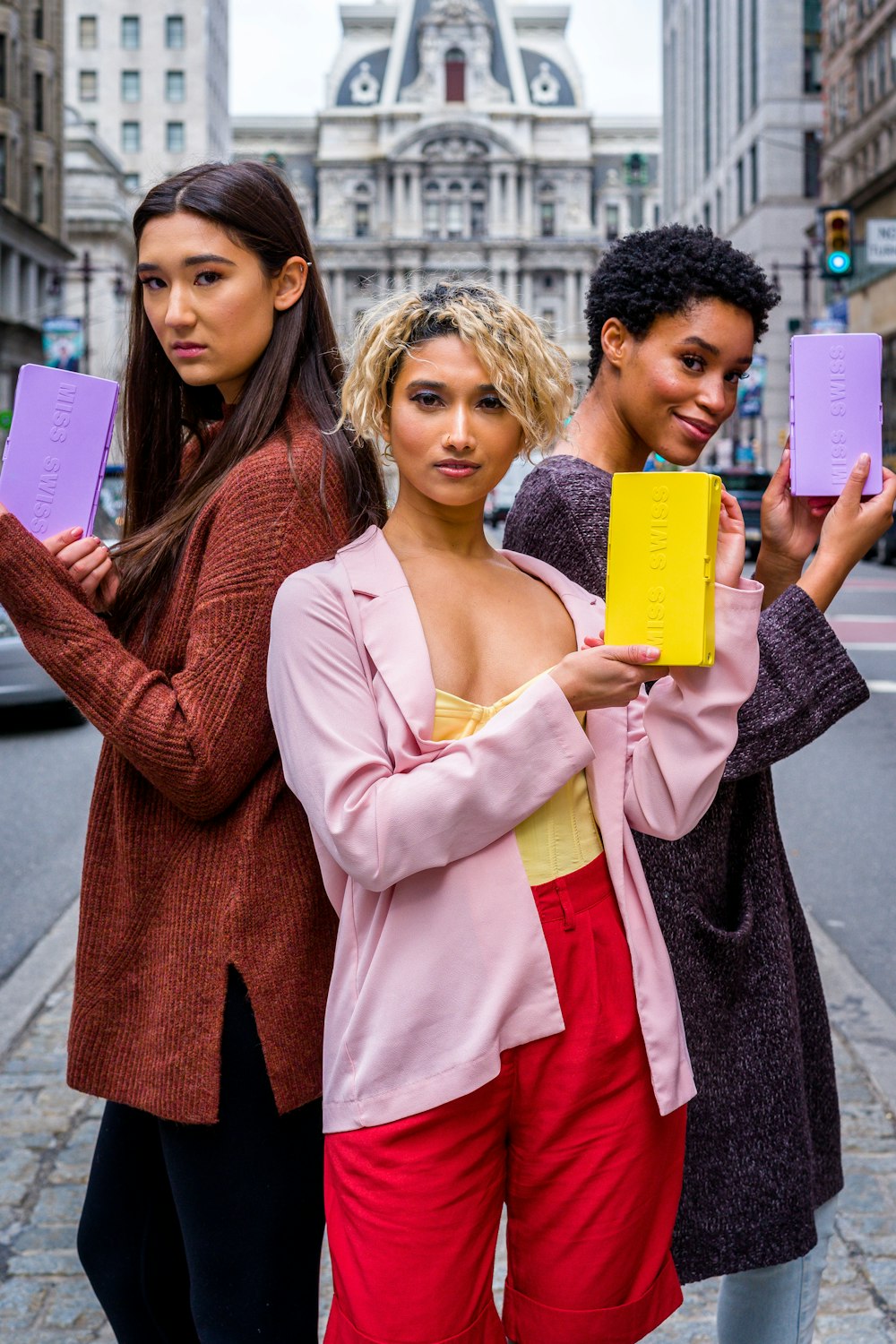 2 women holding yellow paper