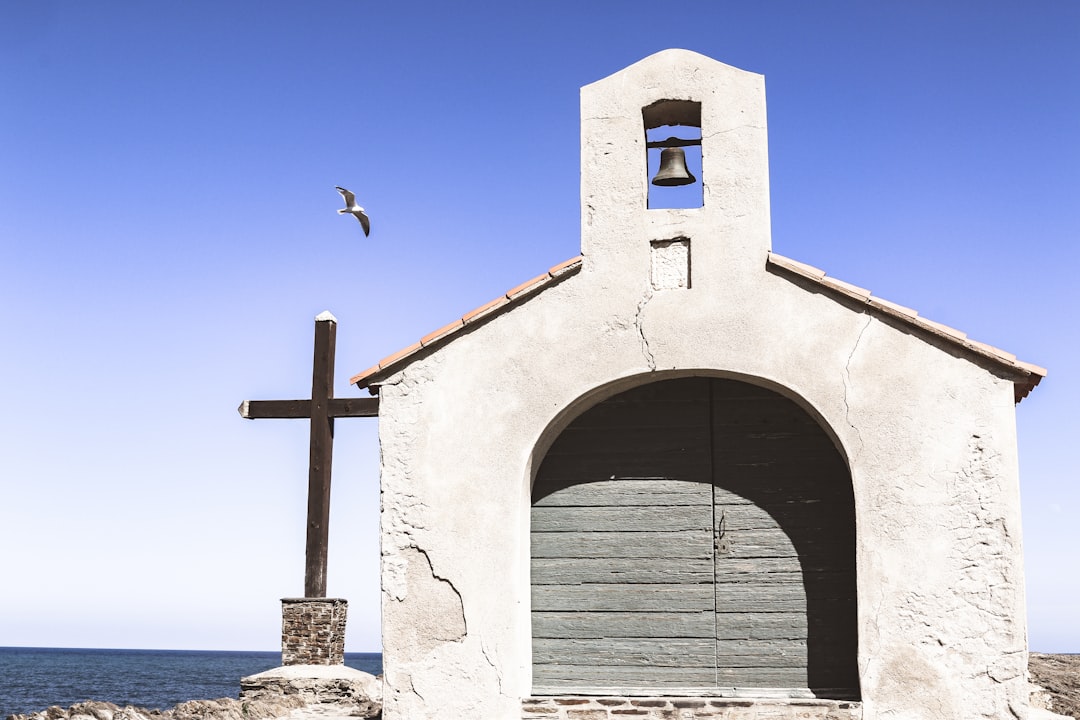 white concrete building with black metal window frame