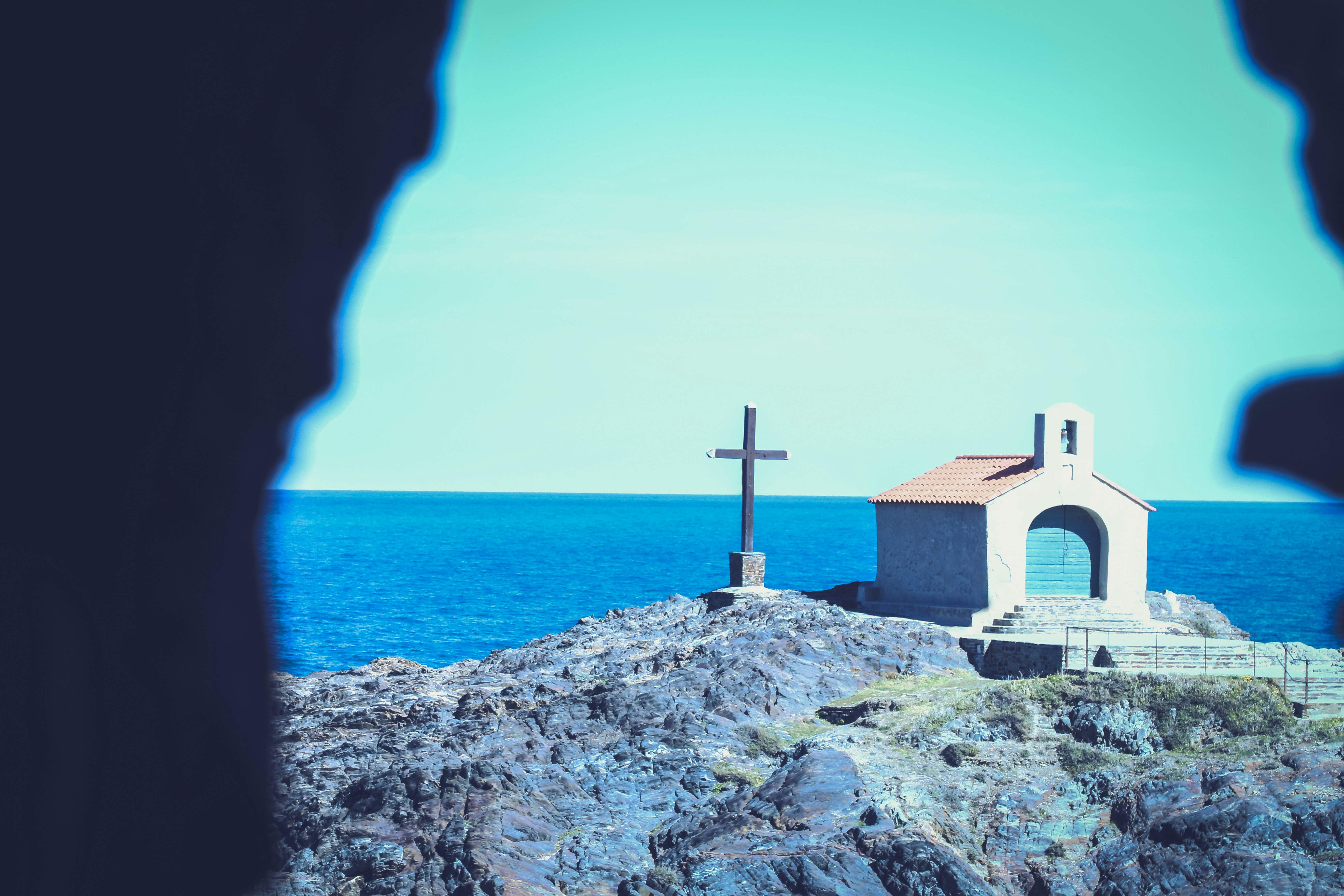 brown and white concrete building near body of water during daytime, 
