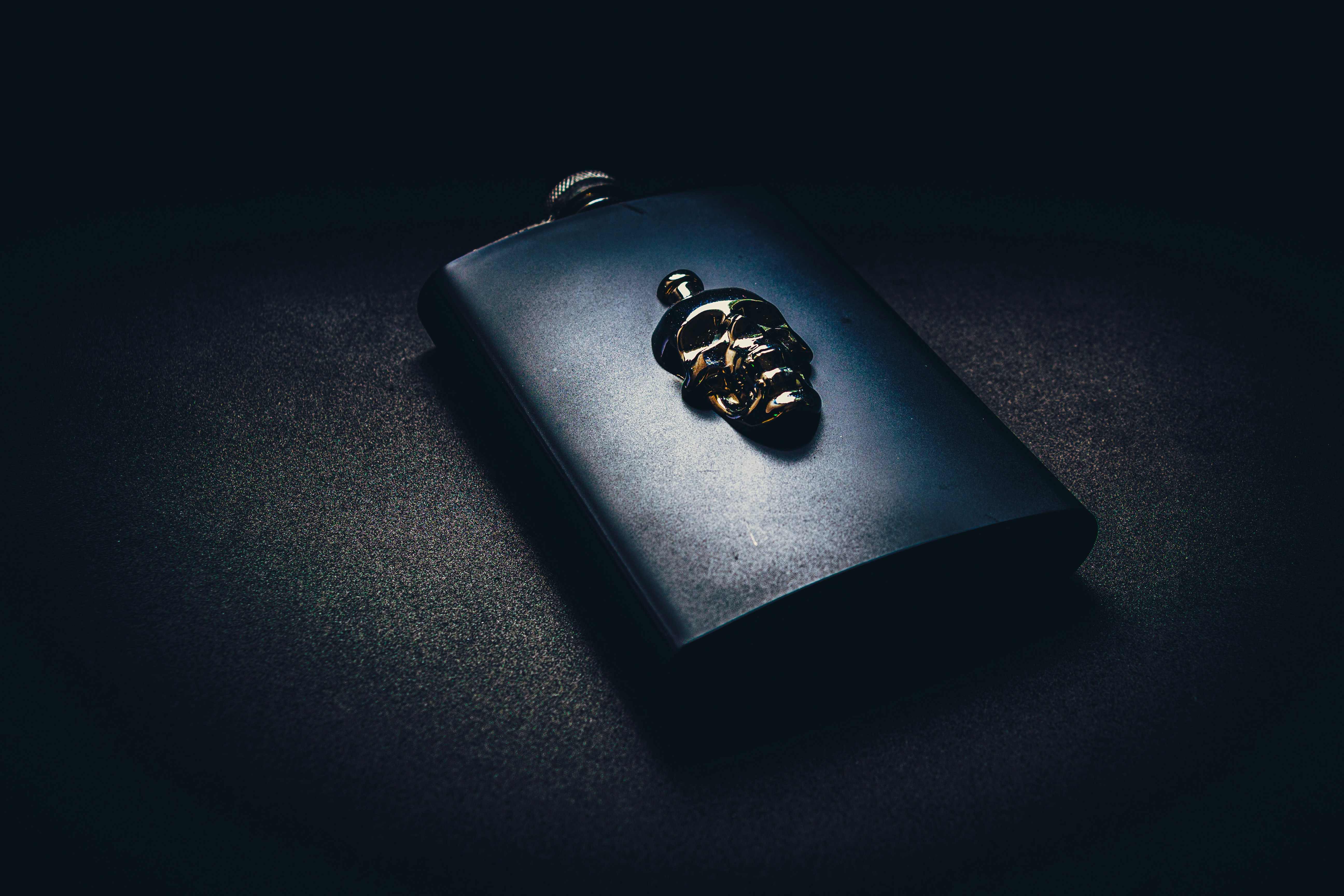 black leather wallet on black surface