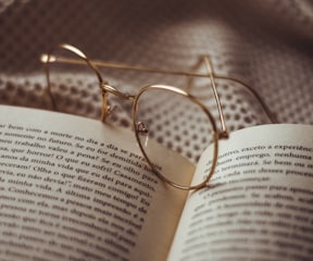 gold framed eyeglasses on book page