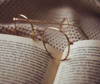 gold framed eyeglasses on book page