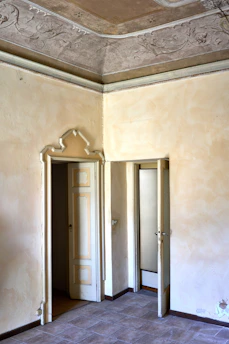 Interior view of a freshly renovated room showcasing smooth plastered walls and elegant tiling.