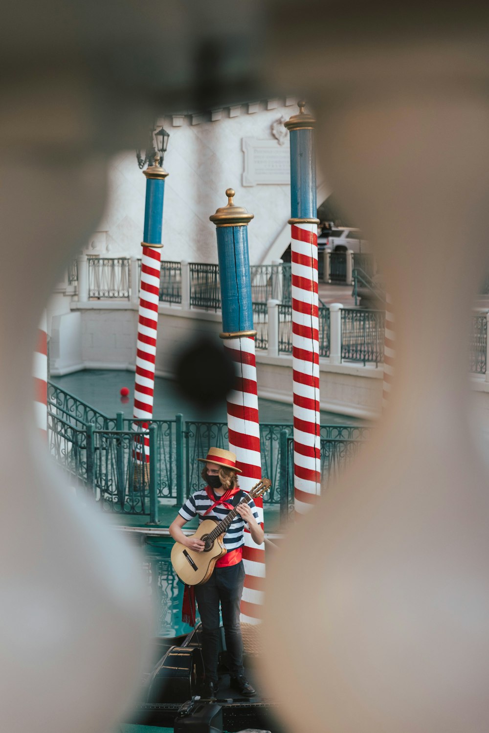 man in black and white striped shirt sitting on white concrete stairs