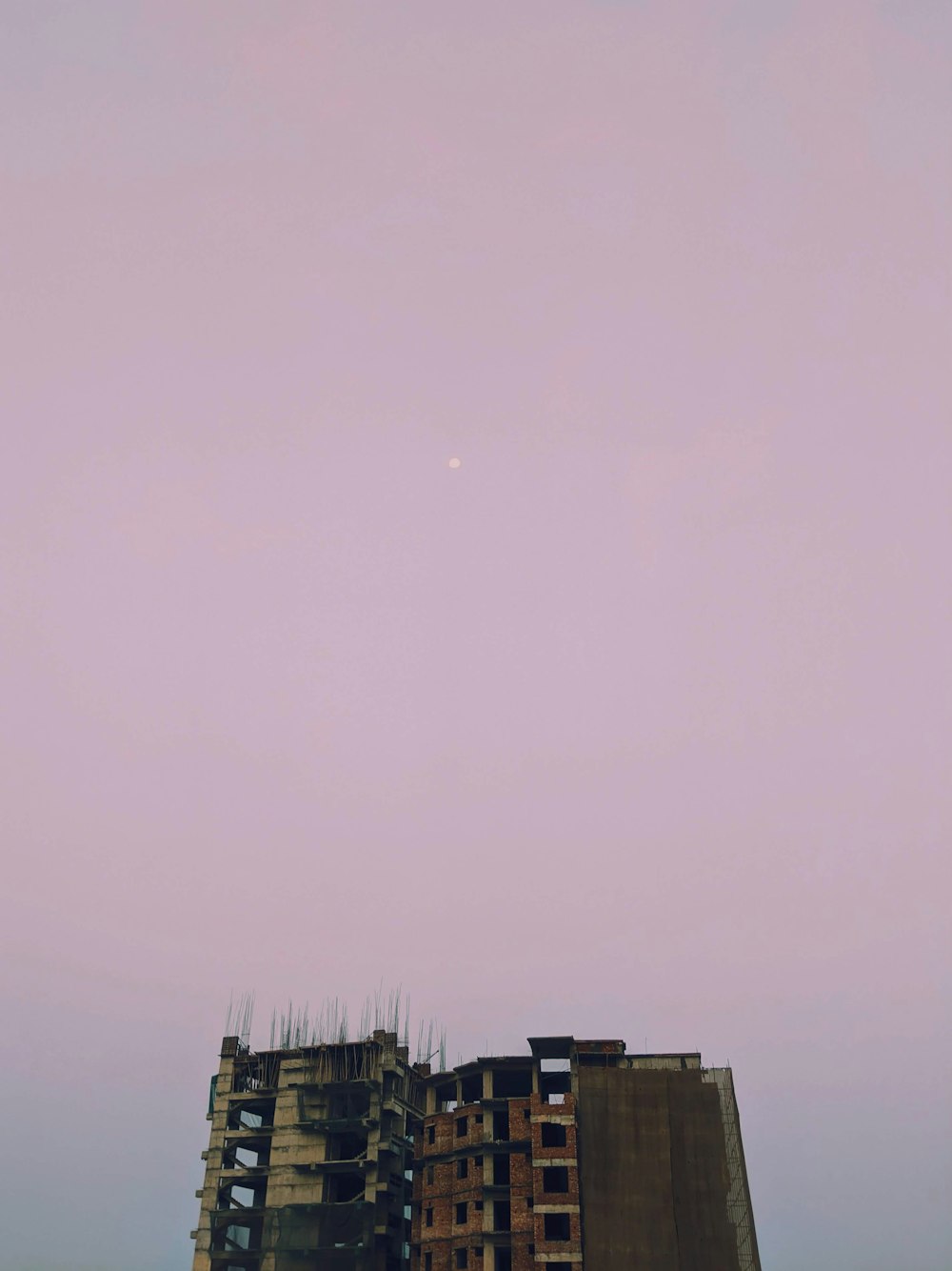 brown concrete building under gray sky